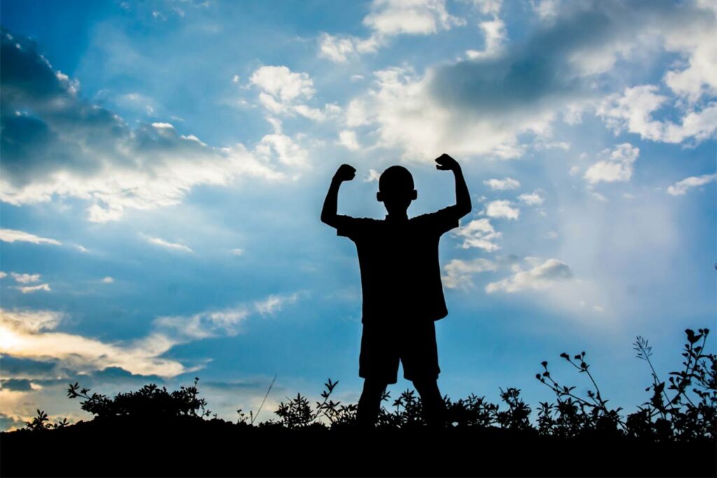 image of a boy flexing and looking into the sky