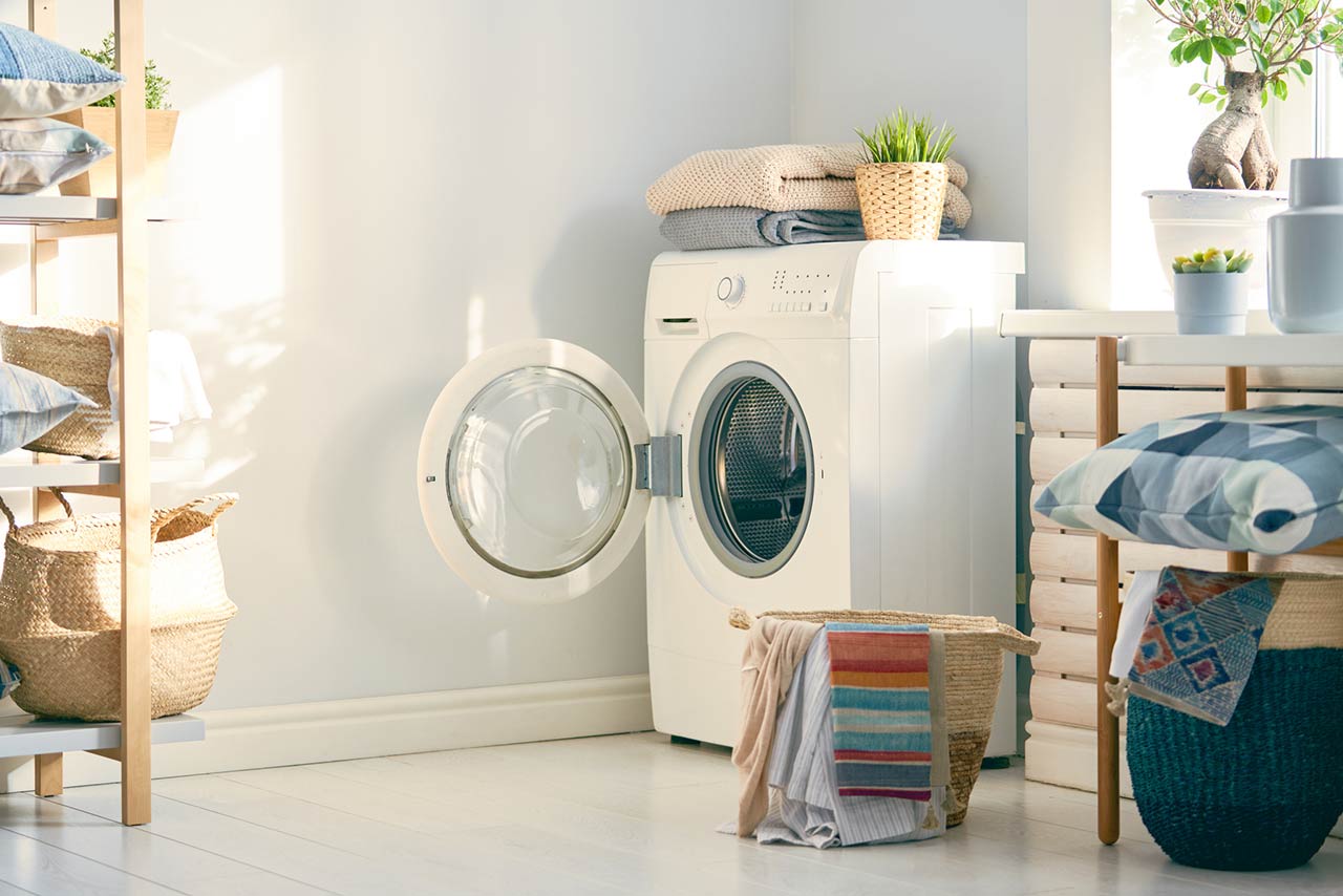 Interior of a real laundry room with a washing machine at home